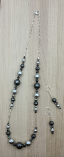 Silver crystal pearls*, grey silver hematite, chrome crystals*, & liquid silver combine to create a neutral, but stunning necklace & matching earrings!