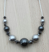 Silver crystal pearls*, grey silver hematite, chrome crystals*, & liquid silver combine to create a neutral, but stunning necklace