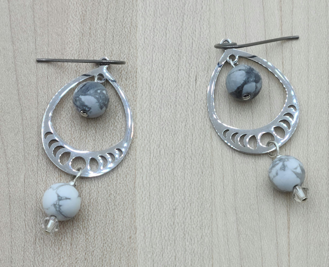 Precision cut stainless steel  teardrops host white & grey howlite stones and tiny crystals* in these lovely earrings.